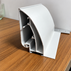 Thanh nhôm bật cạnh 8cm màu bạc đặt trên bàn gỗ